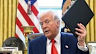 Trump holding an executive order in the Oval Office on Wednesday.