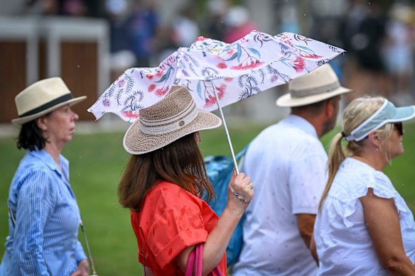 Some umbrellas struggled under the heavy rain.