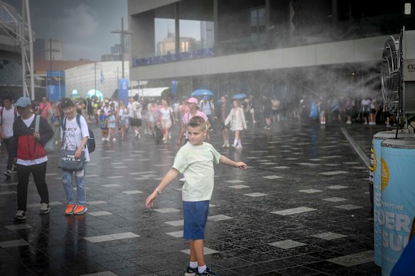 Misting fans kept going as the rain started at Melbourne Park.