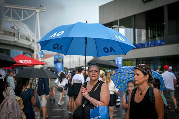 Fans brave the elements at Melbourne Park.