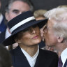 President Donald Trump attempts to kiss First Lady Melania Trump but is blocked by her hat. 