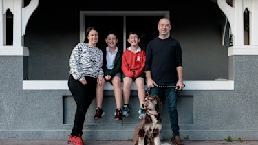 Neil and Jackie Blum with their children, Alfie and Charlie, and their dog Coco, outside their recently sold home in Mascot.