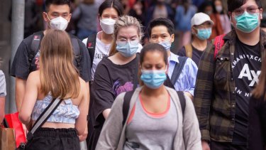 People wearing a range of face masks in Melbourne on Tuesday.