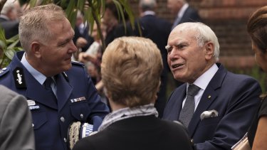 NSW Police Commissioner Mick Fuller chats to former prime minister John Howard at the funeral of Alan Davidson.
