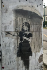 Nola, also known as Umbrella Girl or Rain Girl, first appeared in 2008, painted by Banksy on the streets of the Marigny neighbourhood in the city of New Orleans, Louisiana, three years after the tragic events of Hurricane Katrina. 