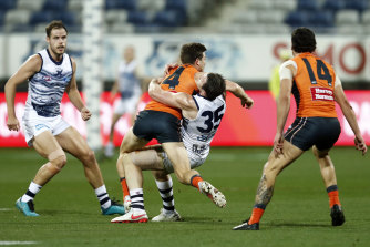Toby Greene catches Patrick Dangerfield high as he tries to fend off a tackle.
