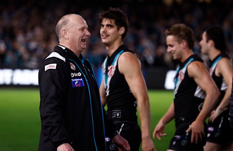 Port Adelaide coach Ken Hinkley exchanging words with Hawthorn players after the match.