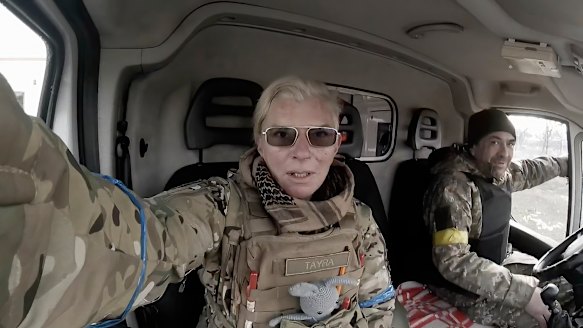 Yuliia Paievska, known as Taira, and her driver Serhiy sit in a vehicle in Mariupol, Ukraine. She last appeared on March 21 on Russian television as a captive, handcuffed.