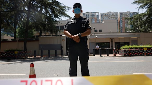 Chinese police officers guard the former United States consulate in Chengdu, formally closed in July.