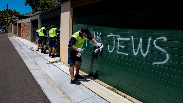 Randwick council cleaners remove antisemitic graffiti from homes in Kingsford on Sunday after a spate of overnight attacks on properties and cars in Sydney’s eastern suburbs.