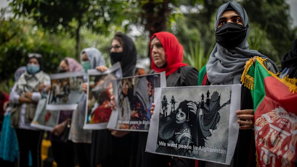 Afghan women hold placards during a protest in New Delhi.
