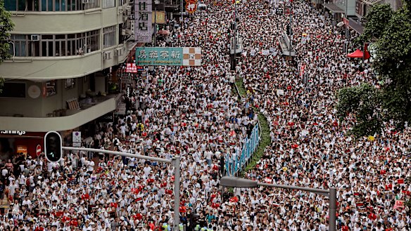 Protesters against proposed amendments to an extradition law march on a downtown street in Hong Kong.