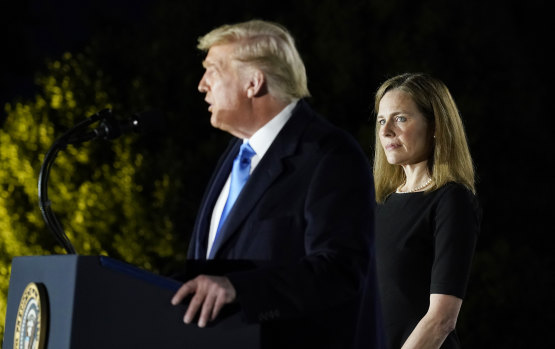 Amy Coney Barrett with Donald Trump on Monday after the Senate confirmed her appointment to the US Supreme Court.