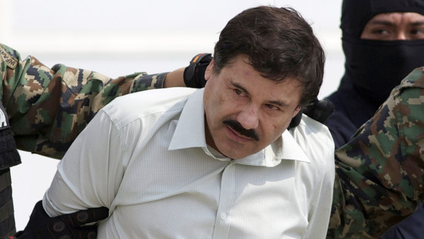 Joaquin "El Chapo" Guzman, the head of Mexico's Sinaloa Cartel, is escorted by police following his 2014 capture in the beach resort town of Mazatlan. 