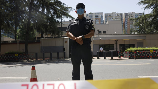 Chinese police officers guard the former United States consulate in Chengdu, formally closed in July.