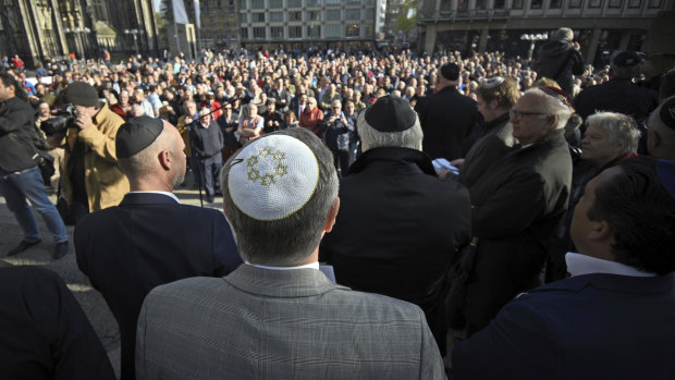 Jewish protesters are seen wearing the kippa, or skullcap, in a protest against anti-Semitism in Berlin.