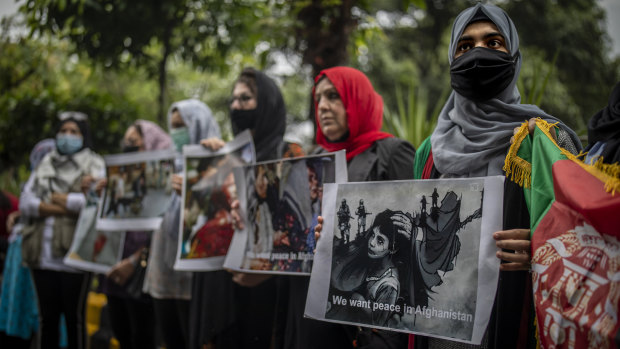 Afghan women hold placards during a protest in New Delhi.