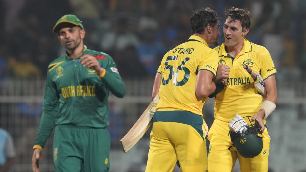 Australia’s captain Pat Cummins and Mitchell Starc celebrate their win in their semi-final match against South Africa.