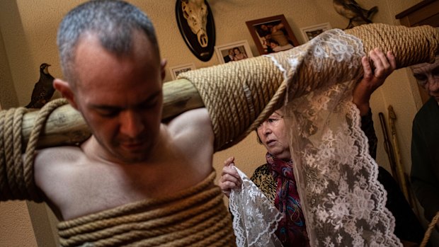 Catholic penitent Daniel gets ready for the procession of 'Los Empalaos' in Valverde de la Vera, western Spain. During the procession the worshipper walks the 'Via Crucis' in silence, barefoot and attached to a beam.