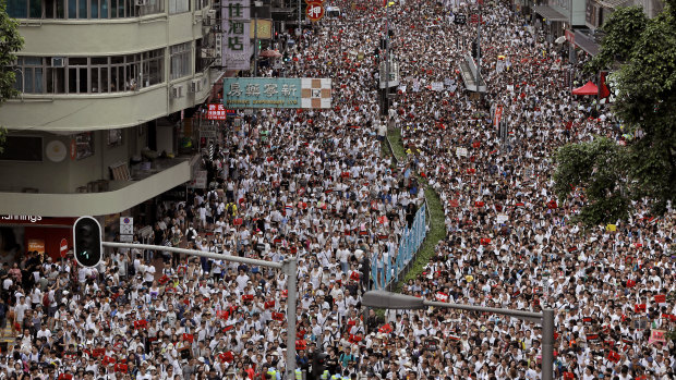 Protesters against proposed amendments to an extradition law march on a downtown street in Hong Kong on Sunday.