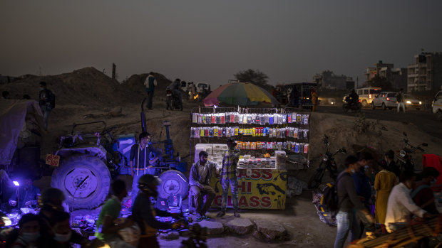 A roadside mobile accessory vendor waits for customers near Delhi, India, where the government has rolled out new regulations for social media companies.