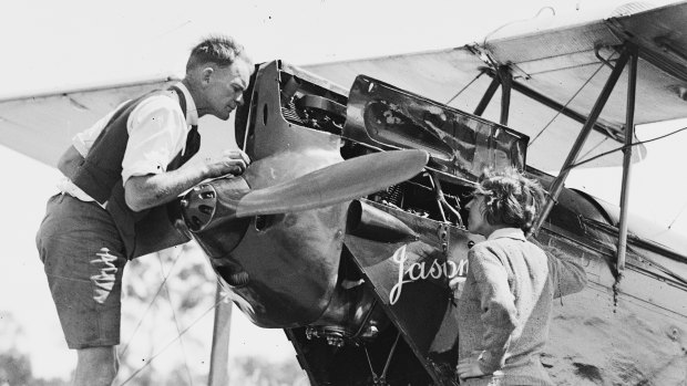 English aviatrix Amy Johnson with a man working on her Gipsy Moth plane "Jason", Sydney, circa 30 May 1930.