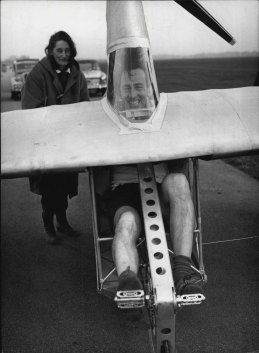 Derek Piggott, 39, puts every effort into the pedals of the flying bicycle as he prepares for a test flight of the novel machine at Lasham gliding centre, near Southampton, 1961. 