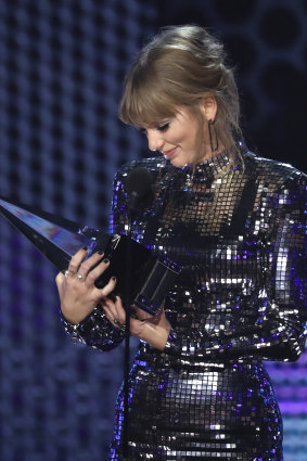 Taylor Swift accepts the award for artist of the year at the American Music Awards.