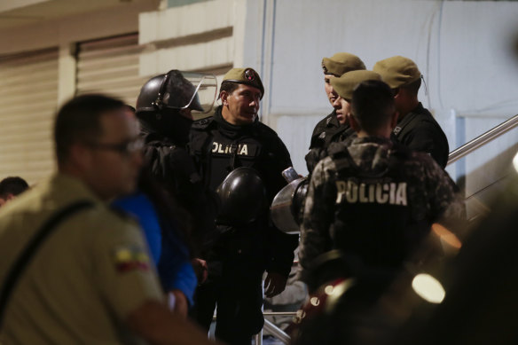 lice guard the hospital where several of the injured were taken after an attack against presidential candidate Fernando Villavicencio in Quito.