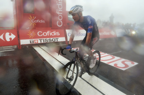 Jay Vine crosses the line on a day hampered by fog and rain.