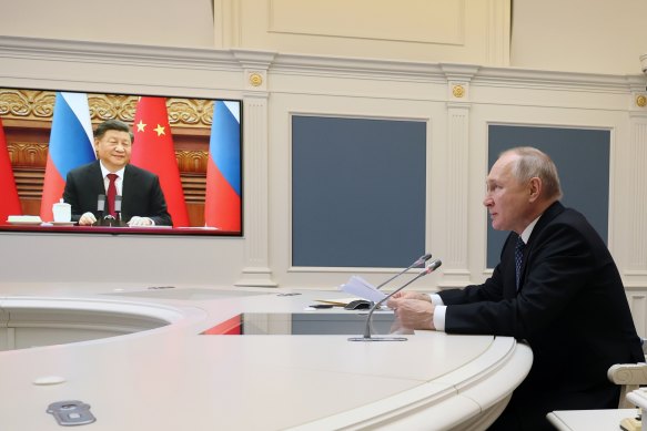 Russian President Vladimir Putin speaks with Chinese President Xi Jinping, seen onscreen,  via video conference in December.