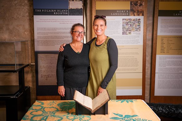 Pauline Reynolds, left, and islander Nat Grube with the register.