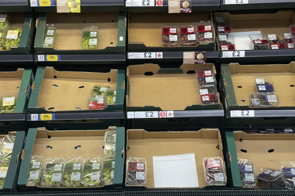 Empty fruit and vegetable shelves at a supermarket in London.