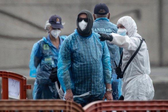 A British citizen talks with medical staff after being evacuated from the MV Hondius in Tenerife.