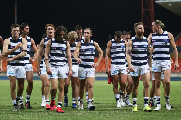 Cats players walk from the field during round one against GWS. 
