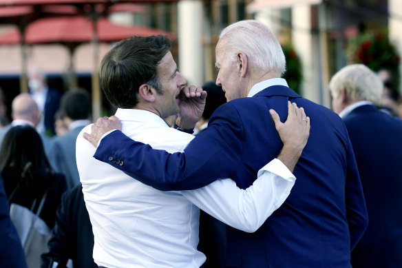 Emmanuel Macron whispers to Joe Biden after their working dinner at the G7 in June.
