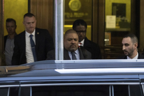 Manhattan District Attorney Alvin Bragg (centre) leaves the District Attorney’s office in New York.