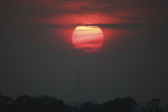 Sunrise over Parliament House, Canberra, with bushfire smoke haze in the air on December 19.