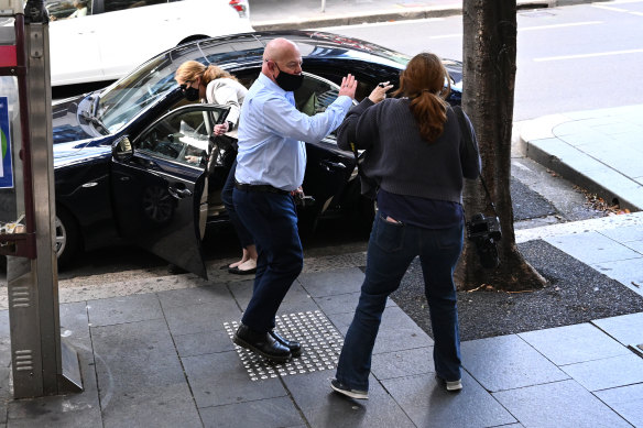 Adam Grimley lashes out at Herald photographer Louise Kennerley outside the Downing Centre courthouse on Tuesday.