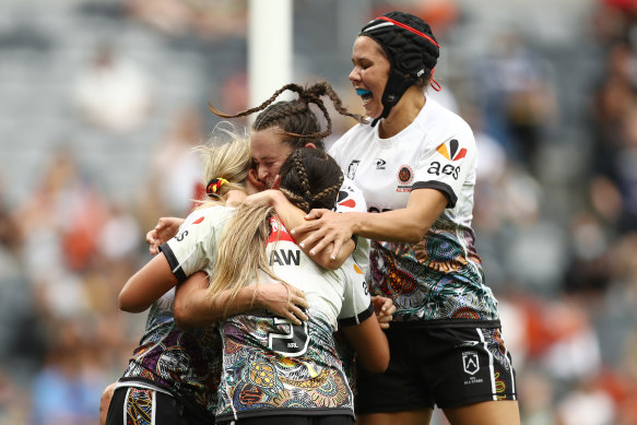 Jaime Chapman is swamped after scoring a try for the Indigenous All Stars against the Maori at CommBank Stadium.