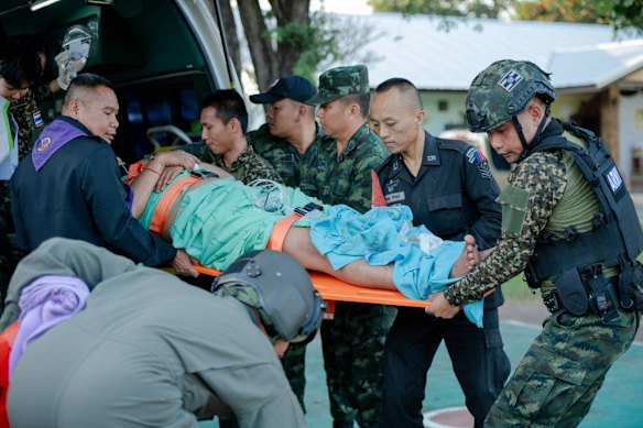 In this photo released by the Royal Thai Army, a wounded Thai soldier is carried to be transferred to a hospital in Si Sa Ket province.