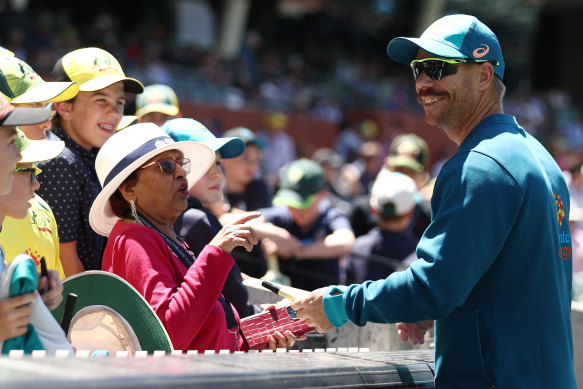 David Warner signs autographs for fans in Adelaide.