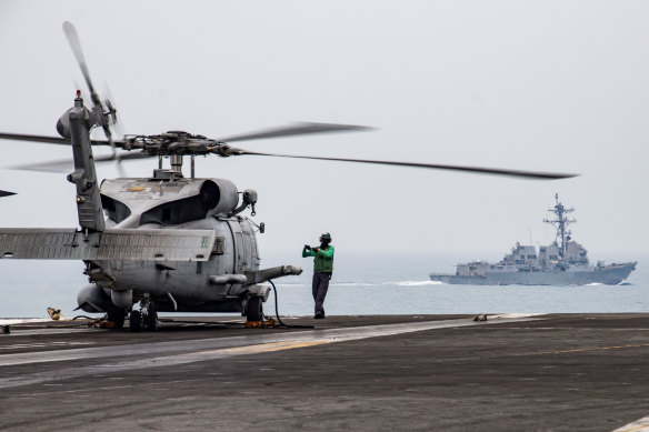 An earlier version of an MH-60R on the flight deck of the USS Ronald Reagan in the South China Sea.