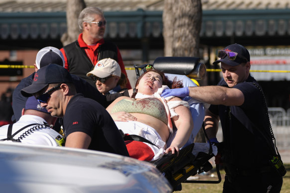 A person is taken to an ambulance following a shooting at the Kansas City Chiefs NFL football Super Bowl celebration.