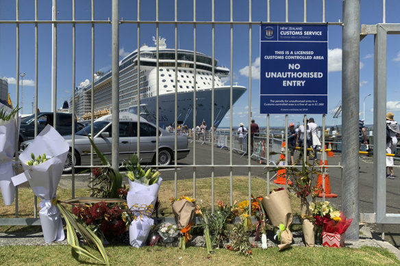 People have left floweers in front of the dock in Tauranga where the cruise ship Ovation of the Seas is moored.