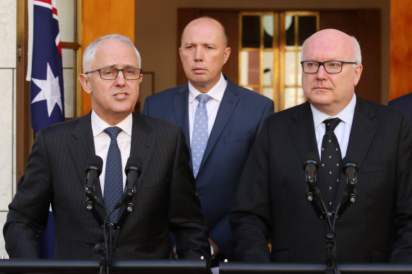 Then-prime minister Malcolm Turnbull announces the appointment of Peter Dutton (centre) as minister for home affairs in 2017, flanked by  then-attorney-general George Brandis (right).