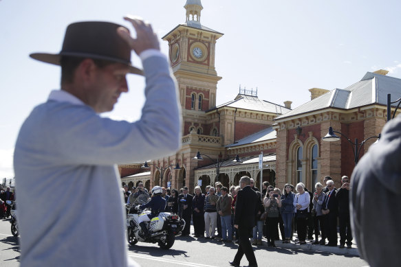 People line the street in Albury after the train arrived carrying Tim Fischer. 
