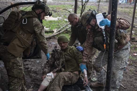Ukrainian soldiers give first aid to a wounded soldier in war-hit Bakhmut, Donetsk region, Ukraine.