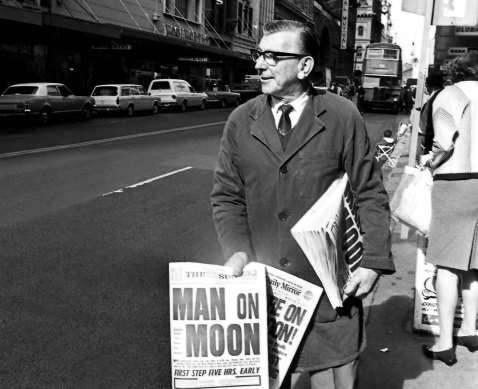 A newspaper seller pictured following the Apollo 11 moon landing in July 1969.