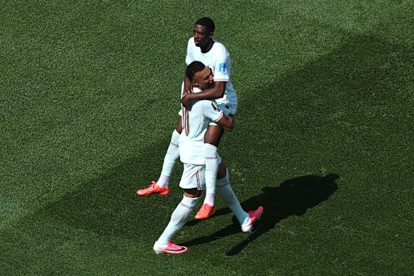 Dembele celebrates with Kylian Mbappe after scoring the team’s third goal.